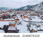 March in the village of Mansky, the snow began to melt, wooden cottages, photo from quadcopter