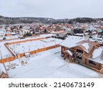 March in the village of Mansky, the snow began to melt, wooden cottages, photo from quadcopter