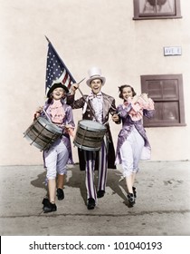 Marching Band Performing In A Parade With An American Flag