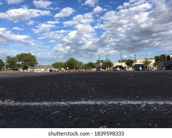 A Marching Band Practice Lot With Scenic Clouds In The Background