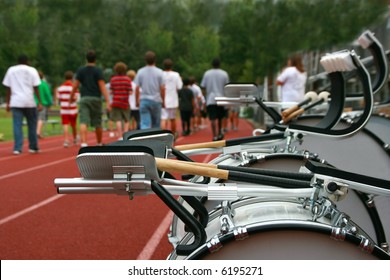 A Marching Band Practices On The High School Track Before A Parade