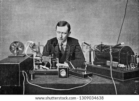 Marconi in front of his receiving device for wireless telegraphy, vintage engraved illustration. From the Universe and Humanity, 1910.
