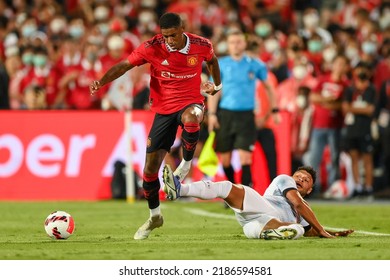 Marcus Rashford (red)of Manchester Utd battles for possession with Alex Oxlade-Chamberlain of Liverpool during the Match Manchester Utd and Liverpool at Rajamangala Stadium on Jul12 2022 Bkk Thailand