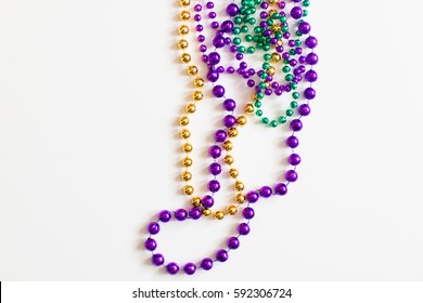 Mardi Gras beads on white background