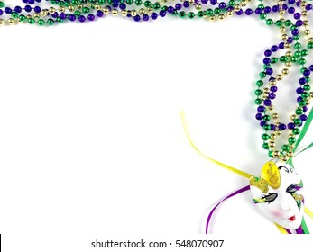 Mardi Gras decor on a white surface with copy space