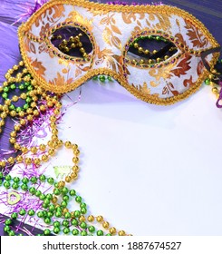 Mardi Gras Mask And Beads Frame For Text On White Space Background. Madi Gras Celebration Fat Tuesday Carnival