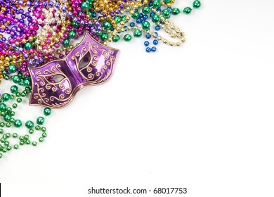 Mardi gras mask and beads in pile