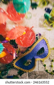 Mardi Gras: Overhead Focus On Mask With Drinks And Trinkets