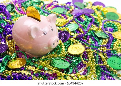 Mardi Gras Piggy Pank On A Pile Of Mardi Gras Beads And Coins