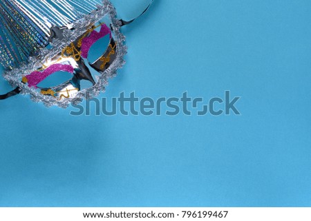 Mardi gras or Purim mask or disguise on a blue background.