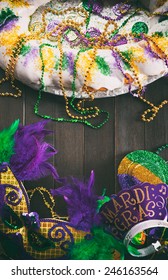 Mardi Gras: Wooden Background For King Cake And Other Party Favors