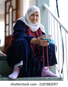 Mardin Turkey
September 2021
Old Woman Sitting On Stairs With Dinner Plate