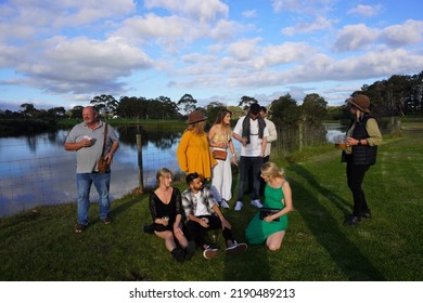 Margaret River Region, Western Australia, Australia, July 2, 2022. Small Group Of People Enjoying Beer In An Idyllic Late Afternoon Landscape