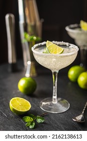 Margarita cocktail with lime and ice on dark wooden table with copy space. Classic Margarita and Daiquiri Cocktail. - Shutterstock ID 2162138613