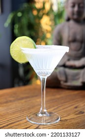 Margarita Cocktail In A Martini Glass With Salt Rim, Decorated With Lime, Selective Focus, With Blurred Background.