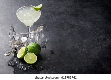 Margarita cocktail on dark stone table. With space for your text - Shutterstock ID 611988941