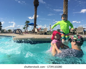 Maricopa, AZ: Children Jump Into A Pool Where The Mother Is Waiting.