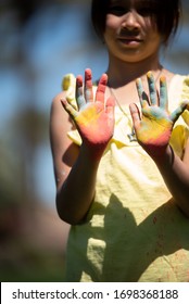 Maricopa AZ/ USA 03/28/2020 Girl At The Park With Colored Powder On Hands