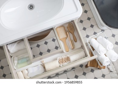 Marie Kondo's Method Organization Of Bathroom Amenities In Modern Open Shelf Case. Toiletries In White Stylish Drawer Or Cupboard Top View. Contemporary Tidying Up Or Storage Household Space