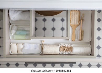 Marie Kondo's Method Organization Of Bathroom Amenities In Modern Open Shelf Case. Toiletries In White Stylish Drawer Or Cupboard Top View. Contemporary Tidying Up Or Storage Household Space