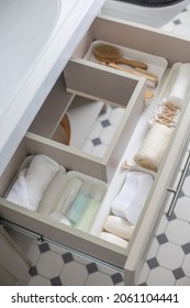 Marie Kondo's Method Organization Of Bathroom Amenities In Modern Open Shelf Case. Toiletries In White Stylish Drawer Or Cupboard Top View. Contemporary Tidying Up Or Storage Household Space