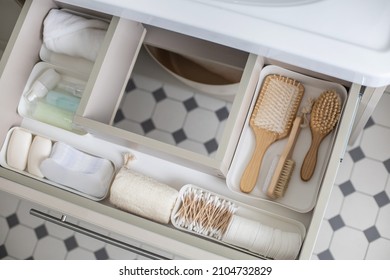 Marie Kondo's Method Organization Of Bathroom Amenities In Modern Open Shelf Case. Toiletries In White Stylish Drawer Or Cupboard Top View. Contemporary Tidying Up Or Storage Household Space