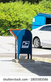 Mariemont, Ohio/ USA - August 29, 2020:  A Blue USPS Mailbox Is In A Parking Lot.