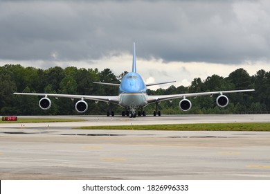 MARIETTA, GA- SEPTEMBER 25, 2020: President Trump Is Aboard Air Force One As It Taxis Toward Dignitaries And Press At Dobbins Air Reserve Base. Head On View With Dark Clouds Above.