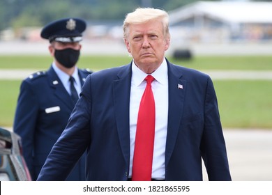 MARIETTA, GA- SEPTEMBER 25, 2020:President Trump arrives on Air Force One at Dobbins Air Reserve Base. Air Force Major General John P. Healy in the background wearing a face mask.