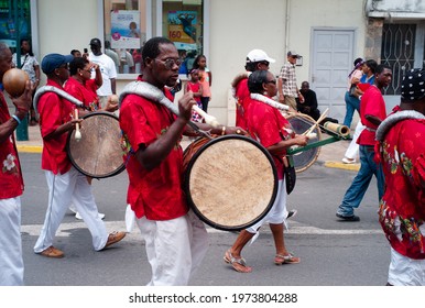 Marigot, Saint Martin - July 14 2013: Parade For Bastille Day Or Quatorze Juillet With A Drummer Playing A Bass Drum Of An Afro-Caribbean Creole Band.