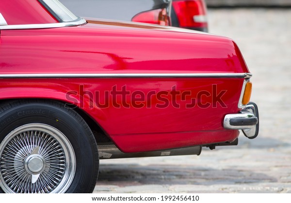 MARIJAMPOLE, LITHUANIA – JUNE 13, 2021: Old\
red classic Mercedes Benz E-Class (W115). At the time Mercedes\
introduced the W114-115 in 1968, they marketed sedans in two size\
classes\
(W114-W115).