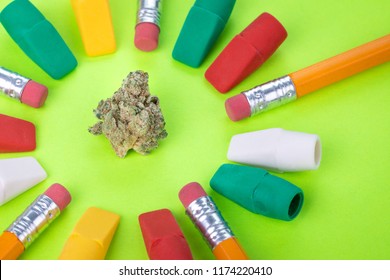 Marijuana Bud In A Circle Of Pencils And Erasers, In Colorful Display Of Drugs And School Supplies