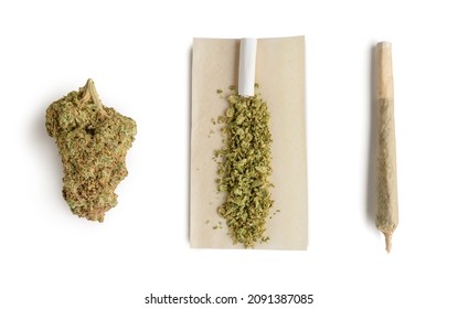 Marijuana bud ,crushed bud of marijuana on the rolling paper and rolling cannabis joint. Isolated on white