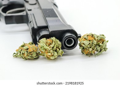 Marijuana Buds, Pills And Black Gun Isolated On White Background (drug Trafficking Concept)