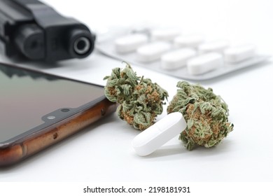 Marijuana Buds, Pills And Black Gun Isolated On White Background (drug Trafficking Concept)