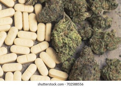 Marijuana Buds And Prescription Pills On Table. Macro Close Up, With 50/50 Split Between Cannabis And Pills. 