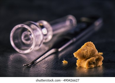 Marijuana Extraction Concentrate Aka Wax Crumble On Dark Background With Tools