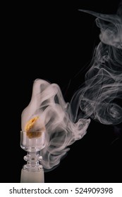 Marijuana Extraction Concentrate Aka Wax Crumble On A Glass Rig With Smoke Isolated On Black Background 