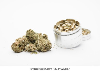 Marijuana format cogollos with aluminum grinder, white background.
