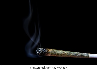 Marijuana joint with smoke on black background