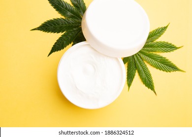 Marijuana Leaf With Cbd Topical Cream On A Yellow Background