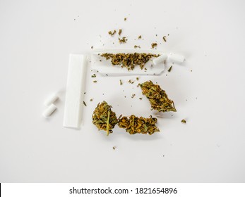 Marijuana And Translucent Roll Paper With Filters For Making Marijuana Cigarettes. Studio Shot On White Background.