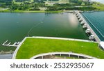 Marina Barrage, Singapore: Aerial view of cityscape and coastline on a overcast afternoon.