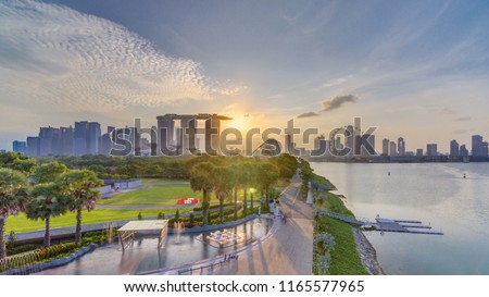 Marina Bay Sands, Gardens by the bay with cloud forest, flower dome and supertrees at sunset timelapse. Top view from marina barrage
