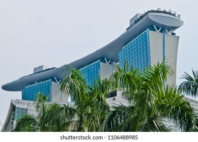 Marina Bay, Singapore/Singapore - 12/12/2012: Close Up View Of Marina Bay Sands Over Palm Trees