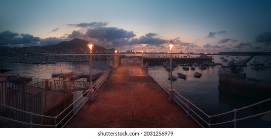 marina with boats at night with streetlamps in Getxo