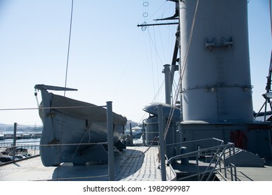 Marina Flisvos, Athens - May 23, 2021: Upper Deck Of The Greek Navy George (or Georgios) Averoff Historic Heavy Cruiser Warship With A Dinghy.