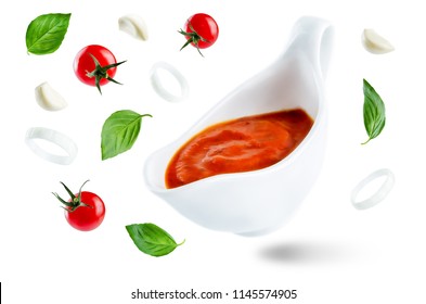 Marinara Sauce With Flying Ingredients To Prepare It Isolated. Toning. Selective Focus