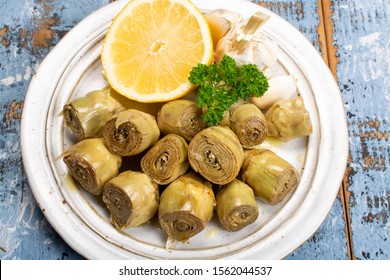 Marinated artichokes hearts with garlic, lemon and olive oil close up