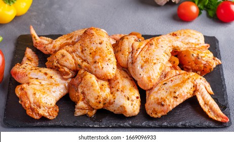 Marinated Chicken Wings On Black Stone Background.